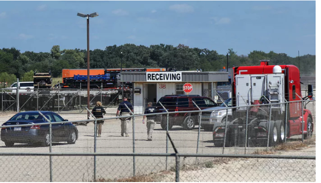 U.S. Immigration and Customs Enforcement agents are seen at the receiving gates of Load Trail, a Sumner-based business agents raided for undocumented workers Tuesday morning. (Lora Arnold/Paris News)(Lora Arnold)